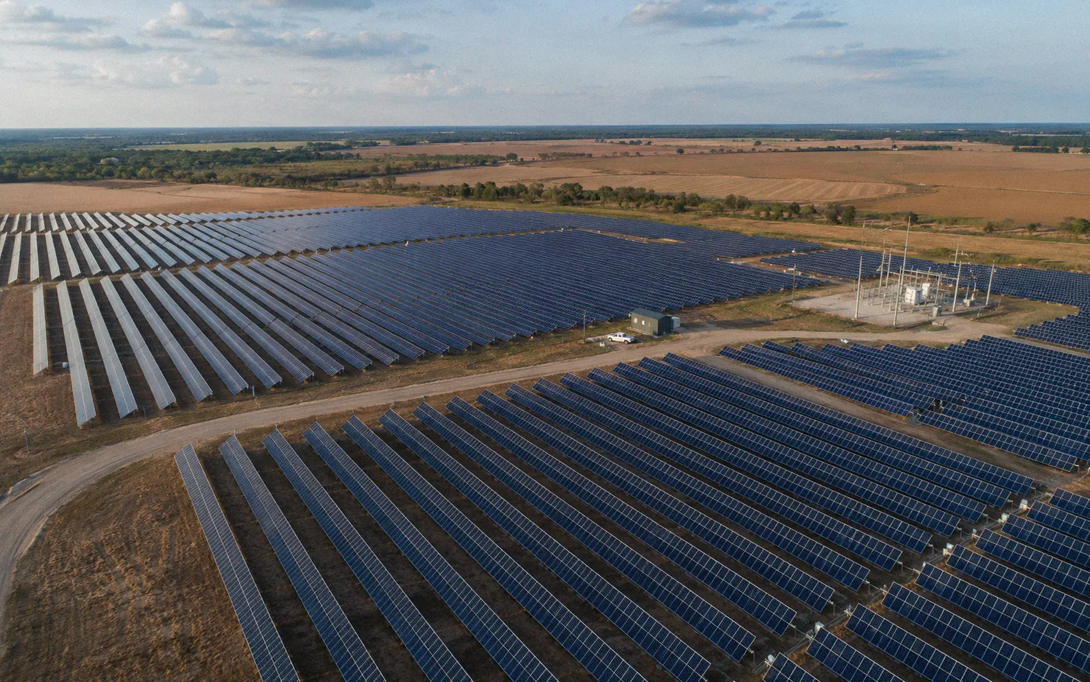 Aerial view of a utility-scale solar farm in a rural landscape