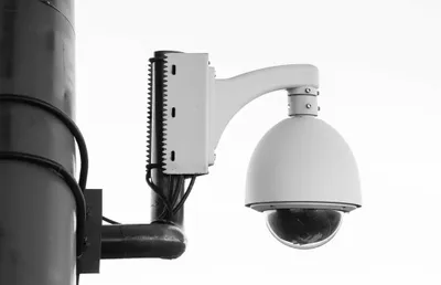 Solar security flood light mounted above a garage door