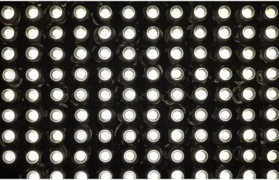 LED light next to a small solar cell on a workbench