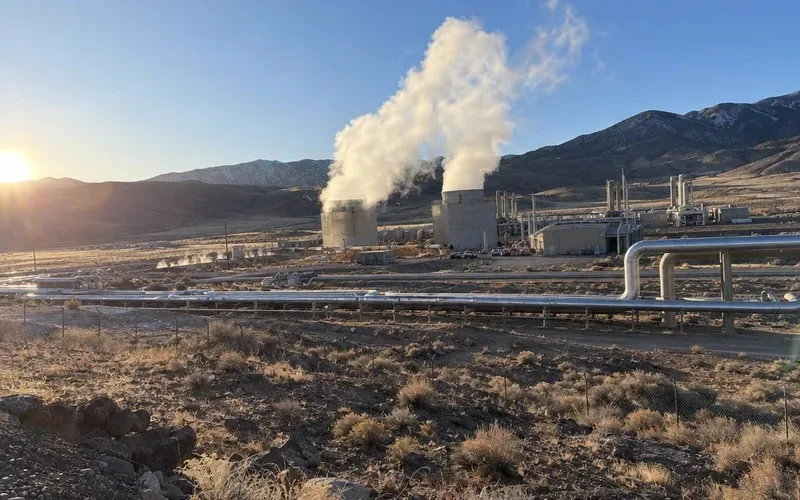 Steam rising from a geothermal power plant in a dry valley