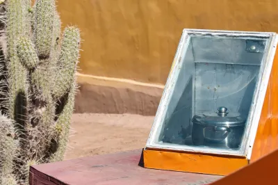 Solar oven in use outdoors during winter with snow around