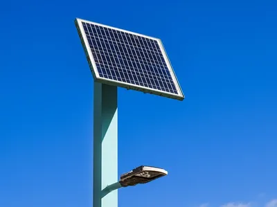 Row of solar pathway lights glowing at dusk along a garden walkway