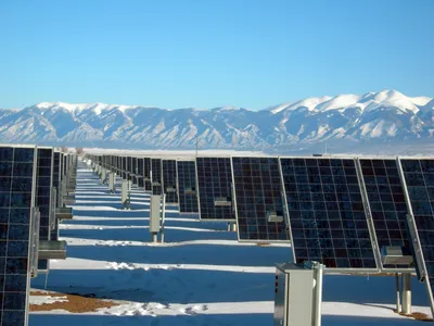 Aerial view of a large-scale solar farm in a field