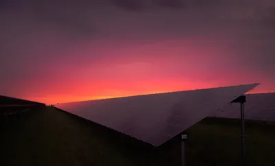 Large solar power plant with rows of panels in a desert
