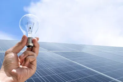Solar panel wired to a battery and LED light setup
