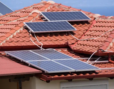 Solar panels and battery bank being installed on a roof