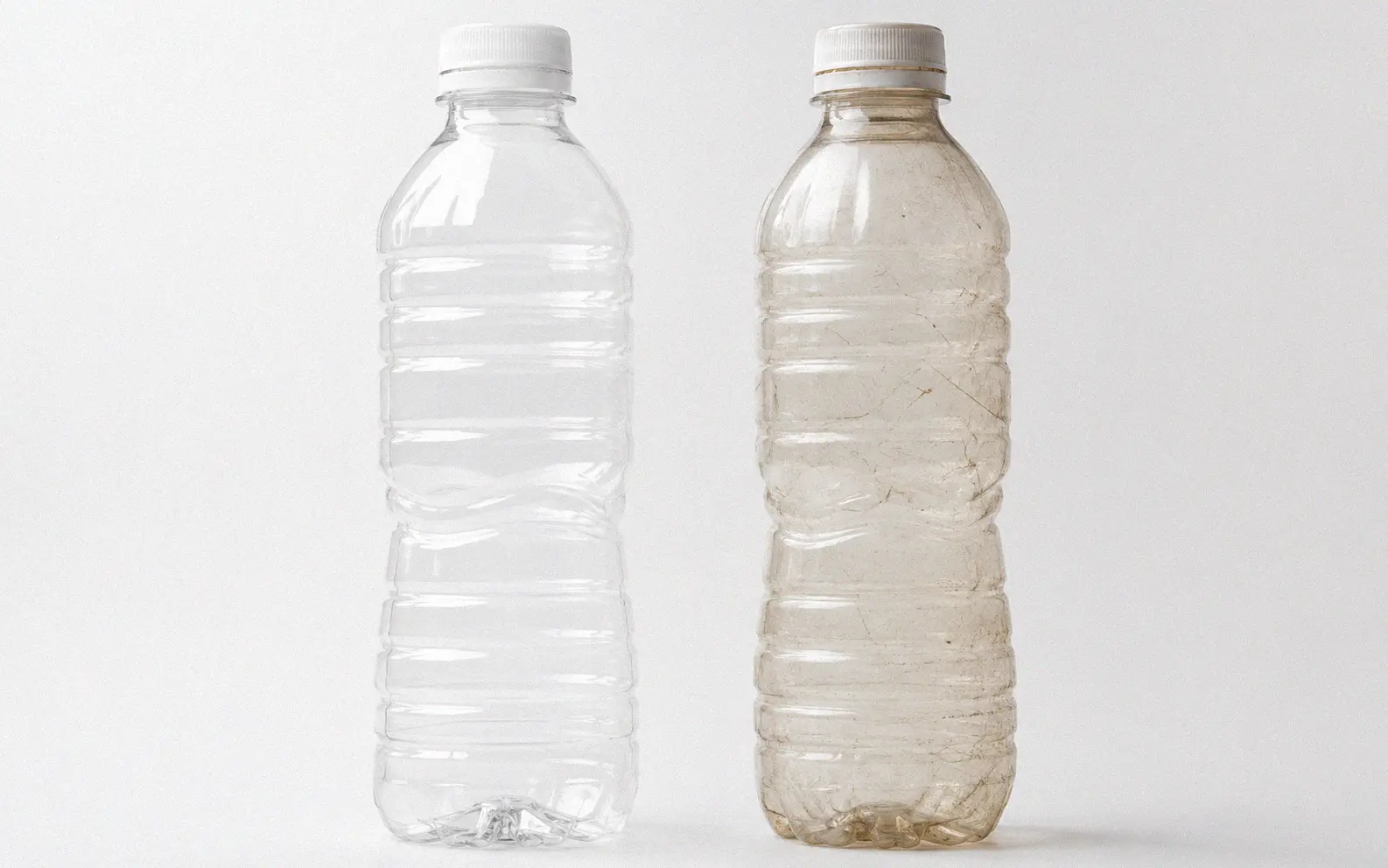 Comparison of a new clear PET bottle next to a scratched cloudy bottle showing UV transmission difference
