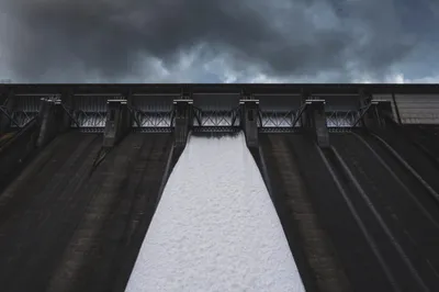 Solar panels beside a hydroelectric dam for comparison