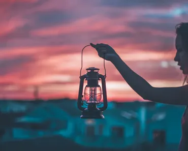 Outdoor solar lanterns hanging in a garden at dusk