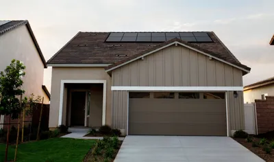Calculator and solar panel showing financial savings
