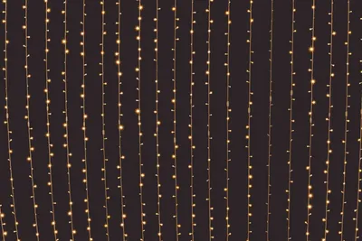 Solar LED string lights on a backyard pergola at night