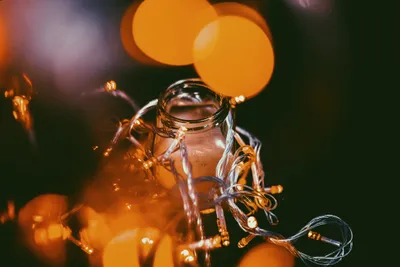 Solar mason jar lights glowing on an outdoor dinner table