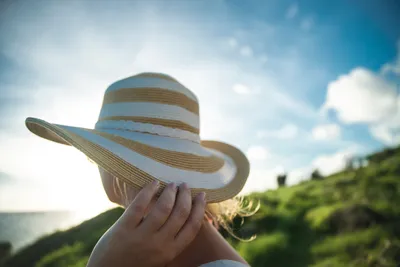 Solar-powered fan hat worn outdoors in sun