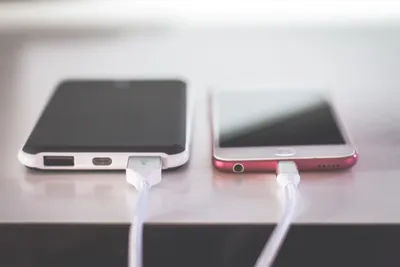 Solar USB charger connected to devices outdoors