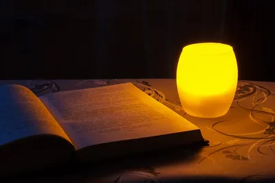 Solar reading light clipped to a book on a lounge chair