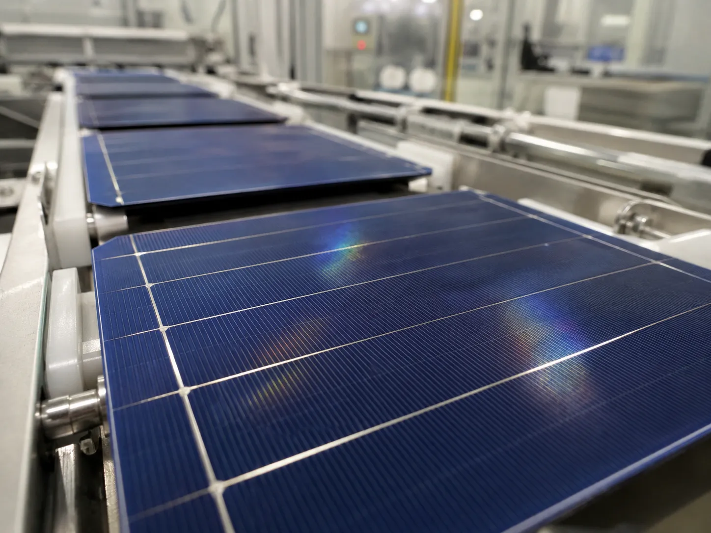 Solar panel production line with robotic arms assembling photovoltaic modules